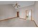 Large bedroom with neutral carpet, a ceiling fan, and access to another room at 104 Stage Line Cv, Louisburg, NC 27549