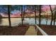 Dock with wooden stairs leading down to lake and a small seating area to enjoy scenic views at 104 Stage Line Cv, Louisburg, NC 27549