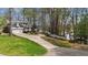 Charming home with an attached garage, long driveway and partial lake view at 104 Stage Line Cv, Louisburg, NC 27549