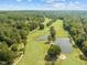 Picturesque golf course with ponds and tree-lined fairways creating a beautiful setting for a round of golf at 104 Stage Line Cv, Louisburg, NC 27549