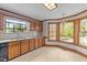 Bright kitchen features wood cabinets, granite counters, tiled backsplash, and a bay window at 104 Stage Line Cv, Louisburg, NC 27549