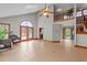 Open living room with tile floors, a soaring ceiling, and access to the outside deck at 104 Stage Line Cv, Louisburg, NC 27549
