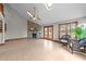 Spacious living room featuring tile floors, a soaring ceiling, fireplace, and access to the back deck at 104 Stage Line Cv, Louisburg, NC 27549