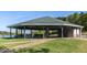 Spacious pavilion with picnic tables providing a perfect spot for outdoor gatherings overlooking the lake at 104 Stage Line Cv, Louisburg, NC 27549