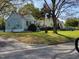 Exterior view of a light-blue one-story home with a well-maintained lawn and mature trees at 109 Plainview Ave, Raleigh, NC 27604