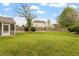 Large, grassy backyard enclosed by a wooden fence, offering ample space for outdoor activities and relaxation at 109 Wyeth Meadows Ln, Holly Springs, NC 27540