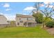 Spacious backyard featuring a well-maintained lawn, a fenced perimeter, and a charming screened-in porch at 109 Wyeth Meadows Ln, Holly Springs, NC 27540