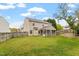 Spacious backyard featuring a well-maintained lawn, a fenced perimeter, and a charming screened-in porch at 109 Wyeth Meadows Ln, Holly Springs, NC 27540