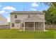 Backyard view featuring a fenced perimeter, a well-maintained lawn, and a charming screened-in porch at 109 Wyeth Meadows Ln, Holly Springs, NC 27540