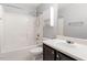 Bathroom features a shower-tub combination with white subway tile and a dark wood vanity at 109 Wyeth Meadows Ln, Holly Springs, NC 27540