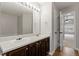Bathroom with double sinks, large mirror, and doorway to a bedroom at 109 Wyeth Meadows Ln, Holly Springs, NC 27540