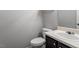 Bathroom features a single sink vanity with dark cabinets and white ceramic sink and toilet at 109 Wyeth Meadows Ln, Holly Springs, NC 27540