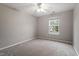 Empty bedroom with neutral carpet, ceiling fan, and window offering natural light at 109 Wyeth Meadows Ln, Holly Springs, NC 27540