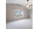 Spacious carpeted bedroom featuring a ceiling fan and a large window with natural light at 109 Wyeth Meadows Ln, Holly Springs, NC 27540