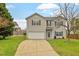 Charming two-story home with a well-maintained lawn, attached garage, and green shutters at 109 Wyeth Meadows Ln, Holly Springs, NC 27540