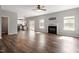 Bright living room with fireplace, ceiling fan and hardwood floors, perfect for relaxation and entertaining at 109 Wyeth Meadows Ln, Holly Springs, NC 27540