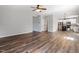 An open floor plan with view of the living room and kitchen and features hardwood floors and neutral paint at 109 Wyeth Meadows Ln, Holly Springs, NC 27540
