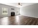 Spacious living room with a cozy fireplace and large windows offering natural light, ideal for Gathering gatherings at 109 Wyeth Meadows Ln, Holly Springs, NC 27540