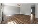 Inviting living room featuring wood floors and plenty of natural light, creating a warm and welcoming atmosphere at 109 Wyeth Meadows Ln, Holly Springs, NC 27540
