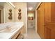 Cozy bathroom featuring floral wallpaper, ample storage, and bright lighting at 1104 W Cole St, Dunn, NC 28334
