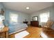 Bedroom features natural light, wood floors, and soothing blue walls at 1104 W Cole St, Dunn, NC 28334