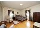 Bedroom with hardwood floors, two windows and patterned bedding at 1104 W Cole St, Dunn, NC 28334