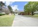 Charming one-story brick home featuring a covered carport and well-maintained front lawn at 1104 W Cole St, Dunn, NC 28334