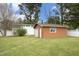Detached garage with green lawn, providing ample space and functionality at 1104 W Cole St, Dunn, NC 28334