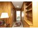 Hallway with wood paneling, built-in shelves, and view to the front door at 1104 W Cole St, Dunn, NC 28334