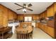 Spacious eat-in kitchen with wood cabinets, ceiling fan, and lots of light at 1104 W Cole St, Dunn, NC 28334