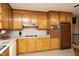Bright kitchen with wood cabinets, tile backsplash, and white countertops at 1104 W Cole St, Dunn, NC 28334