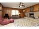 Comfortable living room with a stone fireplace, wood paneling, and a vintage rug at 1104 W Cole St, Dunn, NC 28334