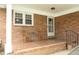 Covered brick patio with seating, offering a cozy and inviting outdoor space at 1104 W Cole St, Dunn, NC 28334