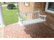 Cozy front porch featuring a classic white porch swing and tiled flooring at 1104 W Cole St, Dunn, NC 28334