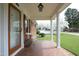 Inviting front porch with white columns, mosaic tile, and a bench overlooking the yard at 1104 W Cole St, Dunn, NC 28334