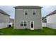 View of the home's backyard, showcasing the vinyl siding, green grass, and a white vinyl fence at 111 Flying Point Ln, Clayton, NC 27520