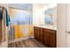 Bathroom featuring double sinks, a decorative shower curtain, and wood-look flooring at 111 Flying Point Ln, Clayton, NC 27520