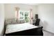 Bright bedroom features a bed, a workspace, and a window with a view at 111 Flying Point Ln, Clayton, NC 27520