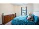 Comfortable bedroom features a large dresser, a window, and a queen bed at 111 Flying Point Ln, Clayton, NC 27520