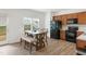 Bright dining area features a wooden table, bench seating, and natural light at 111 Flying Point Ln, Clayton, NC 27520