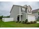 Charming two-story home features a two-car garage, well-maintained lawn, and white fence at 111 Flying Point Ln, Clayton, NC 27520