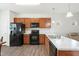 Bright kitchen boasts stone countertops, wooden cabinets, and modern appliances at 111 Flying Point Ln, Clayton, NC 27520