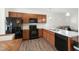 Modern kitchen with stainless steel appliances, stone countertops, and wood cabinets at 111 Flying Point Ln, Clayton, NC 27520