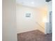 Upper-level landing area with carpeting, a small window, and access to several rooms at 111 Flying Point Ln, Clayton, NC 27520