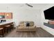 Open-concept living room features a comfortable couch, flat-screen TV, and modern finishes at 111 Flying Point Ln, Clayton, NC 27520