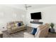 A bright living room features modern furniture, wood floors, and a mounted television at 111 Flying Point Ln, Clayton, NC 27520