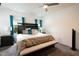 Spacious bedroom with a king bed, bench, ceiling fan, and natural light at 111 Flying Point Ln, Clayton, NC 27520