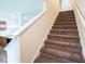 Carpeted staircase leads to the upper level, with a glimpse of the kitchen visible at 111 Flying Point Ln, Clayton, NC 27520