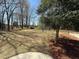 Spacious backyard with mature trees, a storage shed, and plenty of space for outdoor activities at 1117 Country Brooke Dr, Raleigh, NC 27603