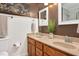 Bathroom with double sink vanity, wood cabinets, and a framed mirror above the sinks at 1117 Country Brooke Dr, Raleigh, NC 27603